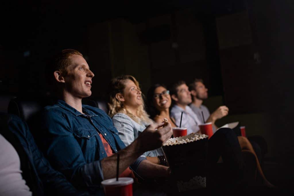 Young people watching movie in cinema