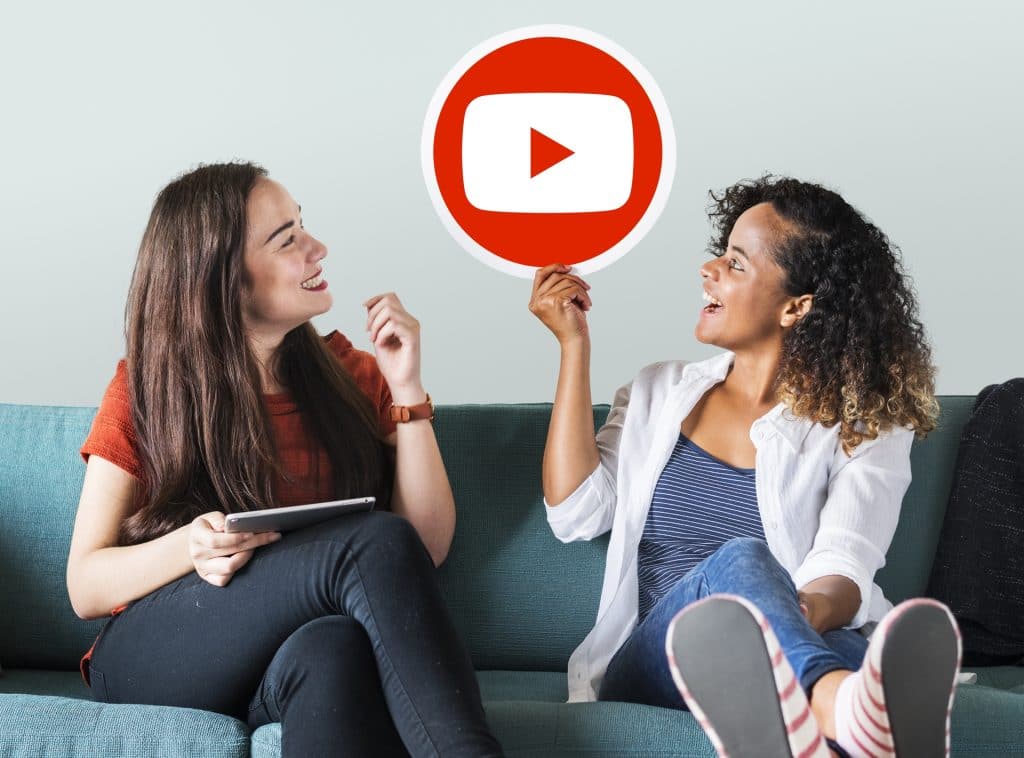 Women holding a YouTube icon